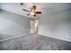 Neutral bedroom with plush carpet, ceiling fan, access to a doorway and neutral paint scheme at 1885 Vintage Dr, Snellville, GA 30078
