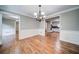 Open dining room area with hardwood floors and view into kitchen at 1885 Vintage Dr, Snellville, GA 30078