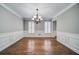 Dining room with hardwood floors, chandelier, and wainscoting detail at 1885 Vintage Dr, Snellville, GA 30078