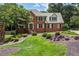 Charming two-story brick home with a well-manicured lawn and colorful landscaping at 1885 Vintage Dr, Snellville, GA 30078