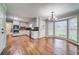 Kitchen with stainless appliances, dark countertops, and hardwood floors overlooking backyard at 1885 Vintage Dr, Snellville, GA 30078