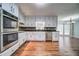 Spacious kitchen with white cabinets, stainless appliances, granite counters and hardwood floors at 1885 Vintage Dr, Snellville, GA 30078