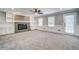 Spacious living room with fireplace, built-in shelves, and plush carpeting at 1885 Vintage Dr, Snellville, GA 30078