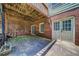 Covered patio area with brick accents, providing a cool outdoor space below the deck at 1885 Vintage Dr, Snellville, GA 30078