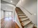 Carpeted staircase with wood trim, leading to a basement with glass paneled doors at 1885 Vintage Dr, Snellville, GA 30078