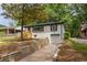 A lovely brick home featuring a one car garage and retaining wall at 208 Silver Springs Sw Cir, Atlanta, GA 30310
