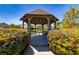 Lakeside gazebo with table and seating, surrounded by manicured bushes at 2103 Drogheda Ln, Marietta, GA 30066