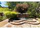 Stone water feature with pool and waterfall in lush backyard setting at 2103 Drogheda Ln, Marietta, GA 30066