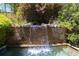 Close-up of a stone waterfall flowing into a pool at 2103 Drogheda Ln, Marietta, GA 30066