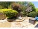 Stone patio with a waterfall feature and landscaped surroundings at 2103 Drogheda Ln, Marietta, GA 30066