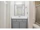 Well-lit bathroom featuring a gray vanity, framed mirror, and shower-tub combination at 3980 Riverlook Se Pkwy # 203, Marietta, GA 30067