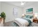 Bright staged bedroom featuring ceiling fan, large window, and decor at 3980 Riverlook Se Pkwy # 203, Marietta, GA 30067