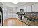 Well-lit kitchen featuring granite counters, tile backsplash, stainless steel appliances, and a sunny bay window at 3980 Riverlook Se Pkwy # 203, Marietta, GA 30067