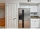 Kitchen area featuring stainless refrigerator, white cabinetry, and granite counters at 3980 Riverlook Se Pkwy # 203, Marietta, GA 30067