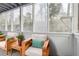 Bright sunroom with two chairs, pillows, and views to the outside at 3980 Riverlook Se Pkwy # 203, Marietta, GA 30067