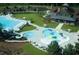Aerial view of a community pool area with several pools, a water slide, and recreational facilities at 1213 Dawnview Dr, Locust Grove, GA 30248