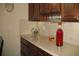 Warm kitchen featuring granite countertops, wood cabinets, and decorative wine and glass rack at 1213 Dawnview Dr, Locust Grove, GA 30248