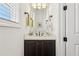 Stylish powder room featuring a dark vanity, marble countertop, and elegant fixtures at 215 Britten Pass, Alpharetta, GA 30009
