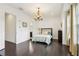 Bright bedroom with hardwood floors, stylish furnishings, and a modern chandelier at 215 Britten Pass, Alpharetta, GA 30009