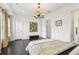 Bedroom featuring a comfortable bed, modern lighting, and access to a glass-enclosed shower at 215 Britten Pass, Alpharetta, GA 30009