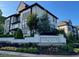 Serenade community entrance featuring manicured landscaping and modern architecture under a blue sky at 215 Britten Pass, Alpharetta, GA 30009