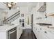 Modern kitchen featuring marble countertops, stainless steel appliances, and ample cabinet space for storage at 215 Britten Pass, Alpharetta, GA 30009