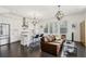 Modern kitchen and living room featuring an island with counter seating, stainless steel appliances, and a chic design at 215 Britten Pass, Alpharetta, GA 30009