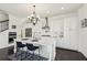 Well-lit kitchen with white cabinets, an island with bar stools, and modern stainless steel appliances at 215 Britten Pass, Alpharetta, GA 30009