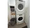Efficient laundry area featuring a stacked washer and dryer, complemented by storage shelves at 215 Britten Pass, Alpharetta, GA 30009