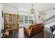 Open-concept living room with hardwood floors and large windows providing ample natural light at 215 Britten Pass, Alpharetta, GA 30009