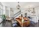 Bright, open-concept living area with dark hardwood floors adjacent to a modern kitchen with stainless steel appliances at 215 Britten Pass, Alpharetta, GA 30009