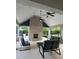 Covered outdoor lounge area with fireplace, ceiling fans and comfortable seating at 215 Britten Pass, Alpharetta, GA 30009