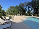 Sparkling community pool with sun loungers, tables and chairs, surrounded by lush landscaping at 215 Britten Pass, Alpharetta, GA 30009