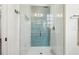 Modern walk-in shower with blue accent tiles, glass enclosure, and brushed nickel fixtures at 215 Britten Pass, Alpharetta, GA 30009