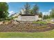 Community entrance sign displaying 'Serenade' with beautiful landscaping and mature trees at 215 Britten Pass, Alpharetta, GA 30009