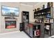Close-up of the bar area featuring dark wood cabinets and shelves with ample storage for liquor and glassware at 4058 Rosebay Way, Conyers, GA 30094