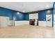 Unfinished basement with a white and blue wall, projection screen, and unfinished concrete wall; ready to be customized at 4058 Rosebay Way, Conyers, GA 30094