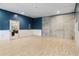 Unfinished basement with hardwood flooring and white and blue walls; a blank canvas ready to be customized at 4058 Rosebay Way, Conyers, GA 30094