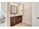 Stylish bathroom with a dark vanity and countertop with neutral wall color at 4058 Rosebay Way, Conyers, GA 30094