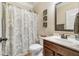 Bathroom area with patterned shower curtain, and neutral colored walls at 4058 Rosebay Way, Conyers, GA 30094