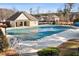 The community pool is depicted with a cover, situated within a fenced area for safety and seasonal use at 4058 Rosebay Way, Conyers, GA 30094