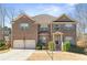 Beautiful two-story brick home with a two-car garage, landscaped yard, and inviting front entrance at 4058 Rosebay Way, Conyers, GA 30094