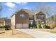 Lovely two-story home with a two-car garage, manicured lawn, mature landscaping, and welcoming entrance at 4058 Rosebay Way, Conyers, GA 30094