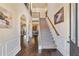 Grand foyer with hardwood floors, staircase, arched doorways, and elegant decor at 4058 Rosebay Way, Conyers, GA 30094