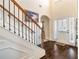 Elegant foyer featuring hardwood floors, staircase with decorative railing, and bright lighting at 4058 Rosebay Way, Conyers, GA 30094