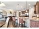 Open kitchen with granite countertops, a breakfast bar, and seamless access to living spaces at 4058 Rosebay Way, Conyers, GA 30094