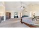 Open main bedroom with vaulted ceilings, tv, seating and carpet floors at 4058 Rosebay Way, Conyers, GA 30094