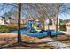 A colorful playground with slides and structures set on a blue rubber base, providing a safe and fun play area at 4058 Rosebay Way, Conyers, GA 30094