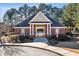 View of the brick pool house with a welcoming entrance and surrounding greenery for a serene recreational experience at 4058 Rosebay Way, Conyers, GA 30094