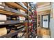 Custom wine cellar featuring wooden racks storing many bottles of wine at 4058 Rosebay Way, Conyers, GA 30094